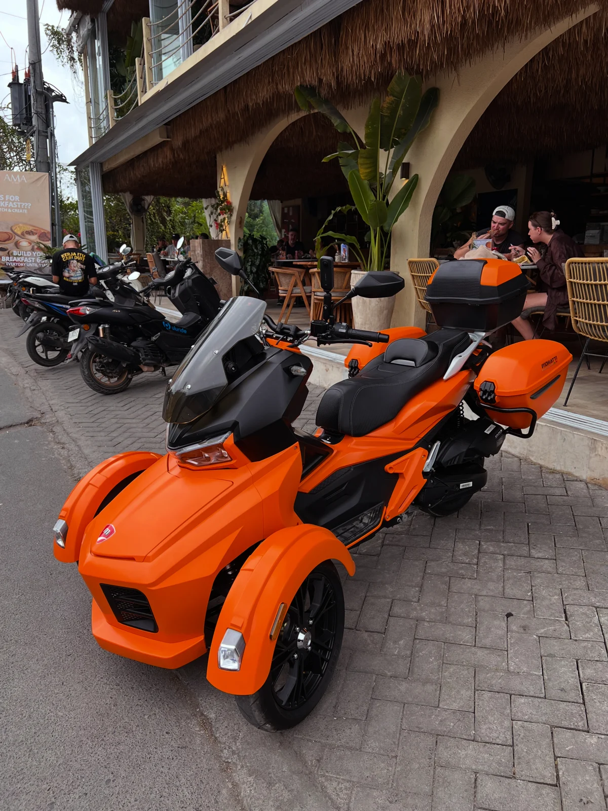 An orange Moratti parked outside a Bali restaurant