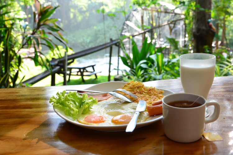 a delicious tropical breakfast bowl with coffee overlooking the Uluwatu forest