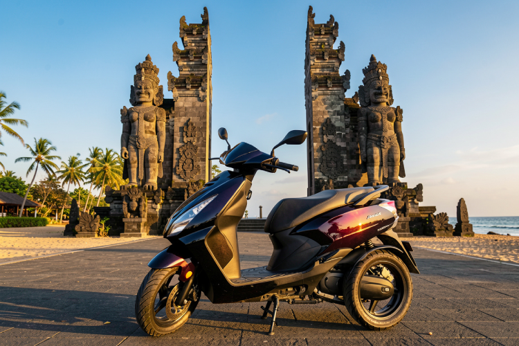 a modern three-wheel scooter parked in front of the giant limestone statues at Pandawa Beach entrance