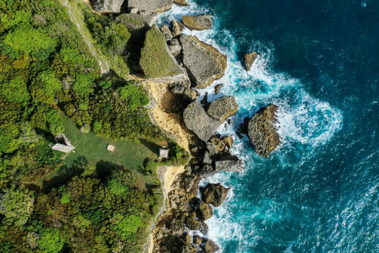 aerial view of Uluwatu cliffs and turquoise ocean in Bali